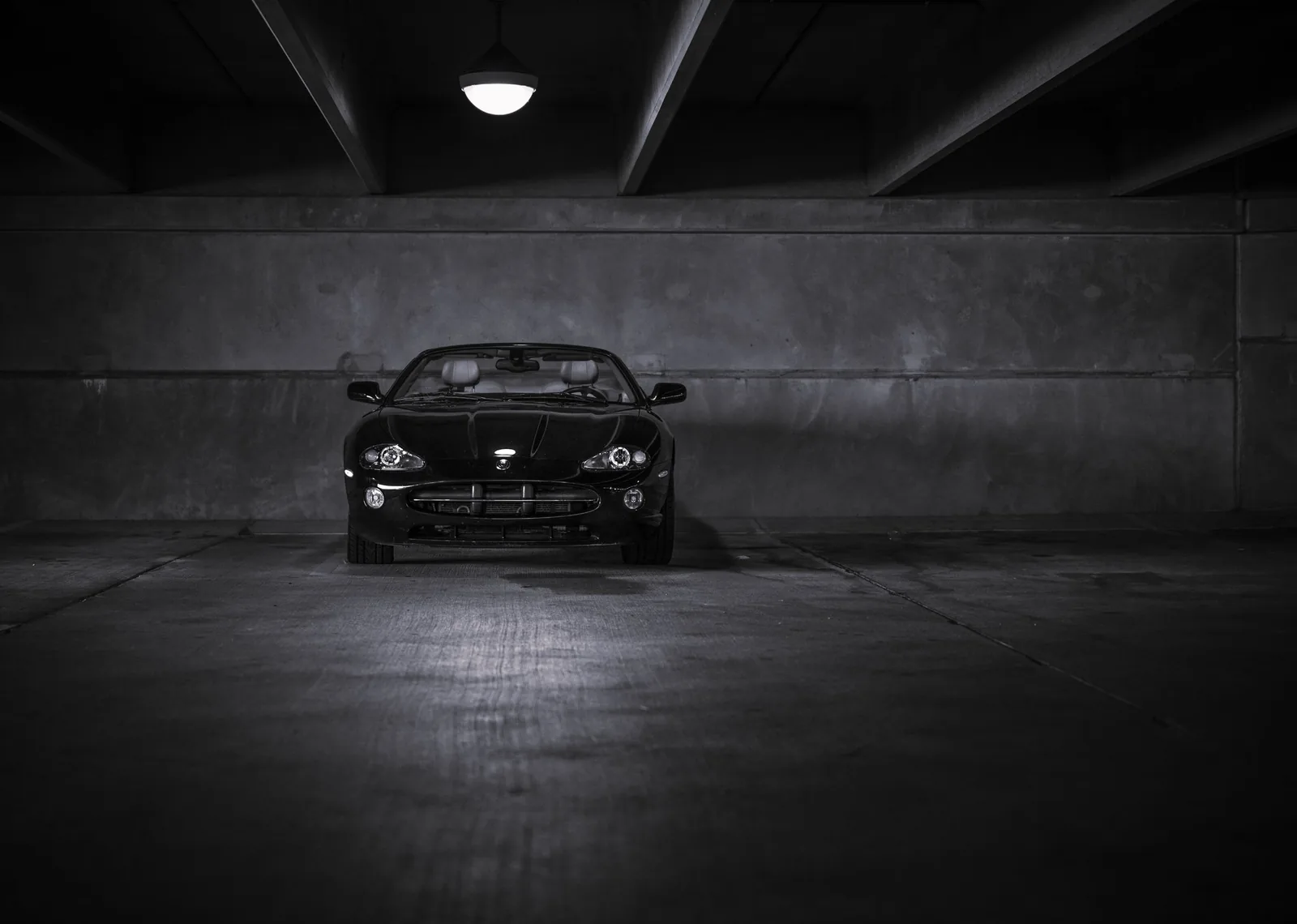 Black coupe parked in a dark tunnel after a full correction